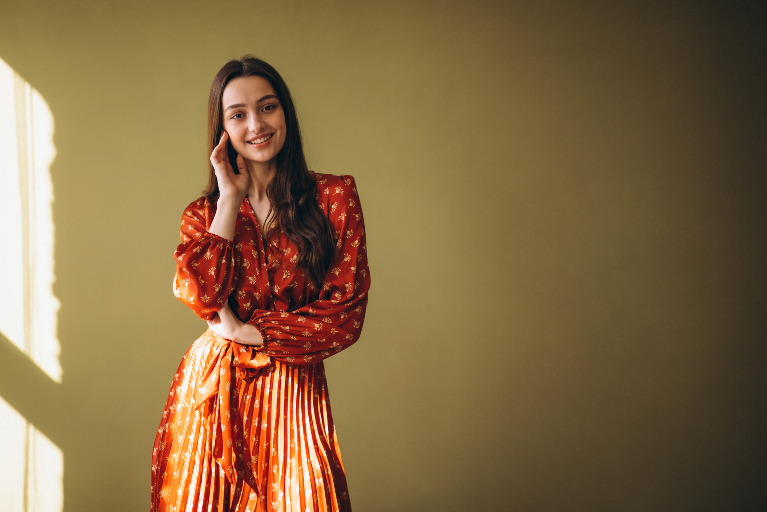 Young woman in a beautiful dress in studio